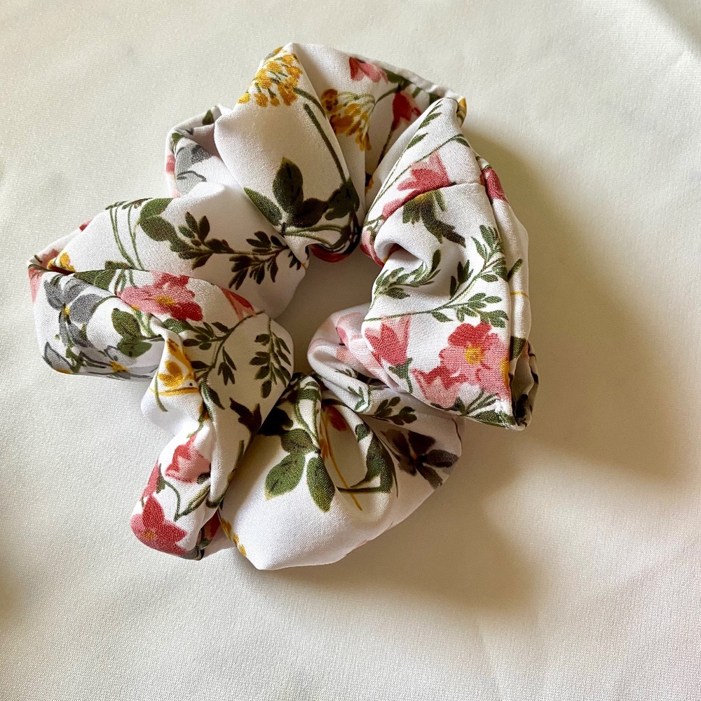 Pink, yellow, and white floral silk scrunchies.